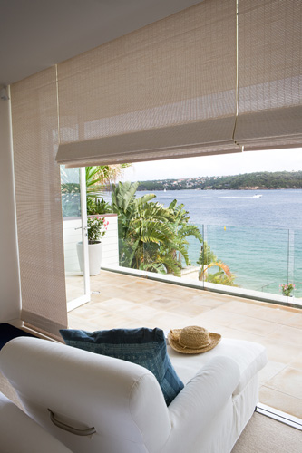 Woven blind over a balcony with an ocean view