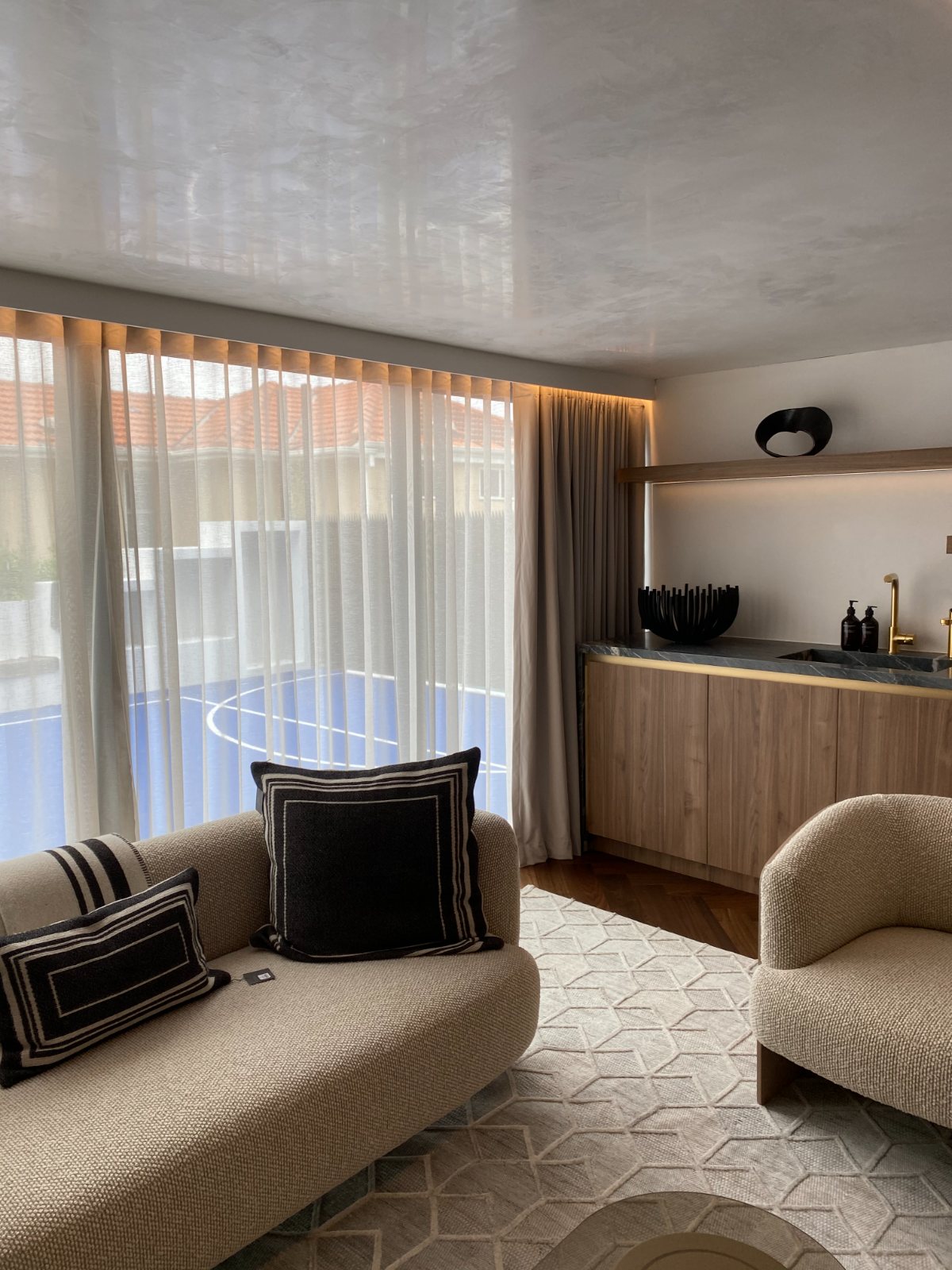 White S-fold sheer curtains in a luxe living room with bouclé furniture