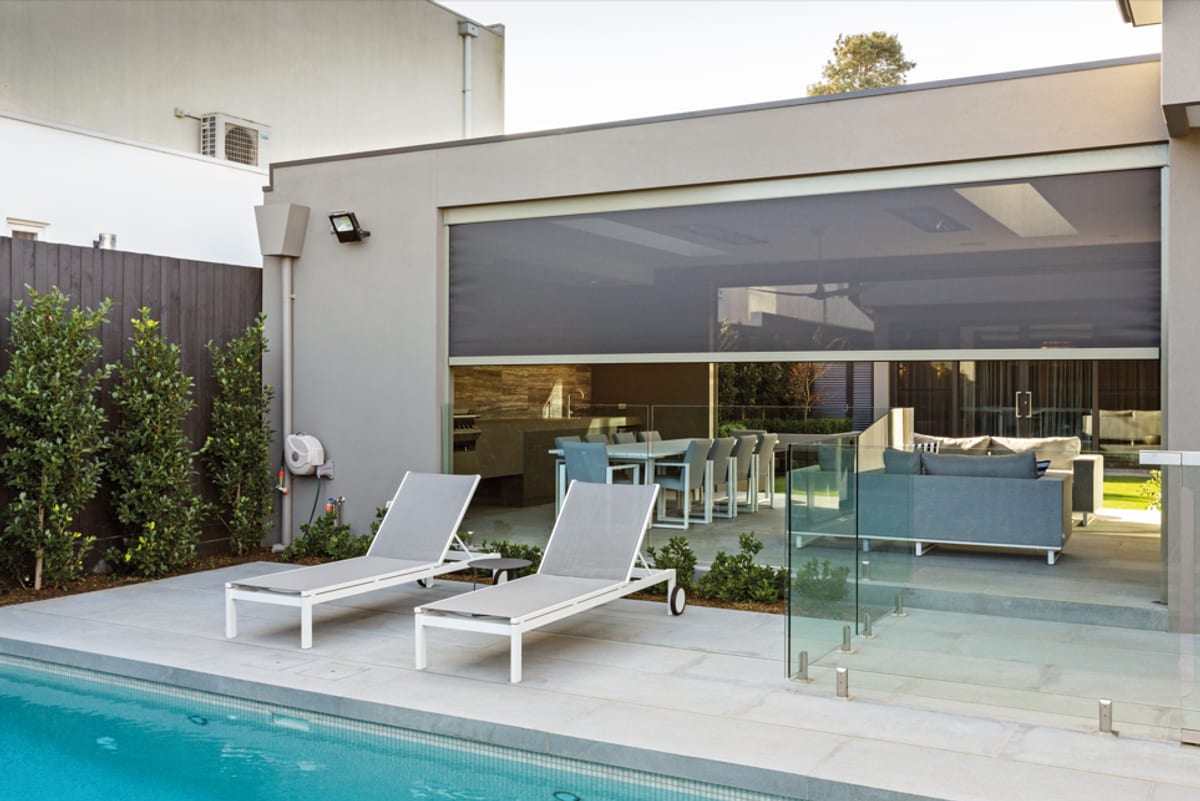Outdoor zip screens shading a poolside alfresco entertaining area